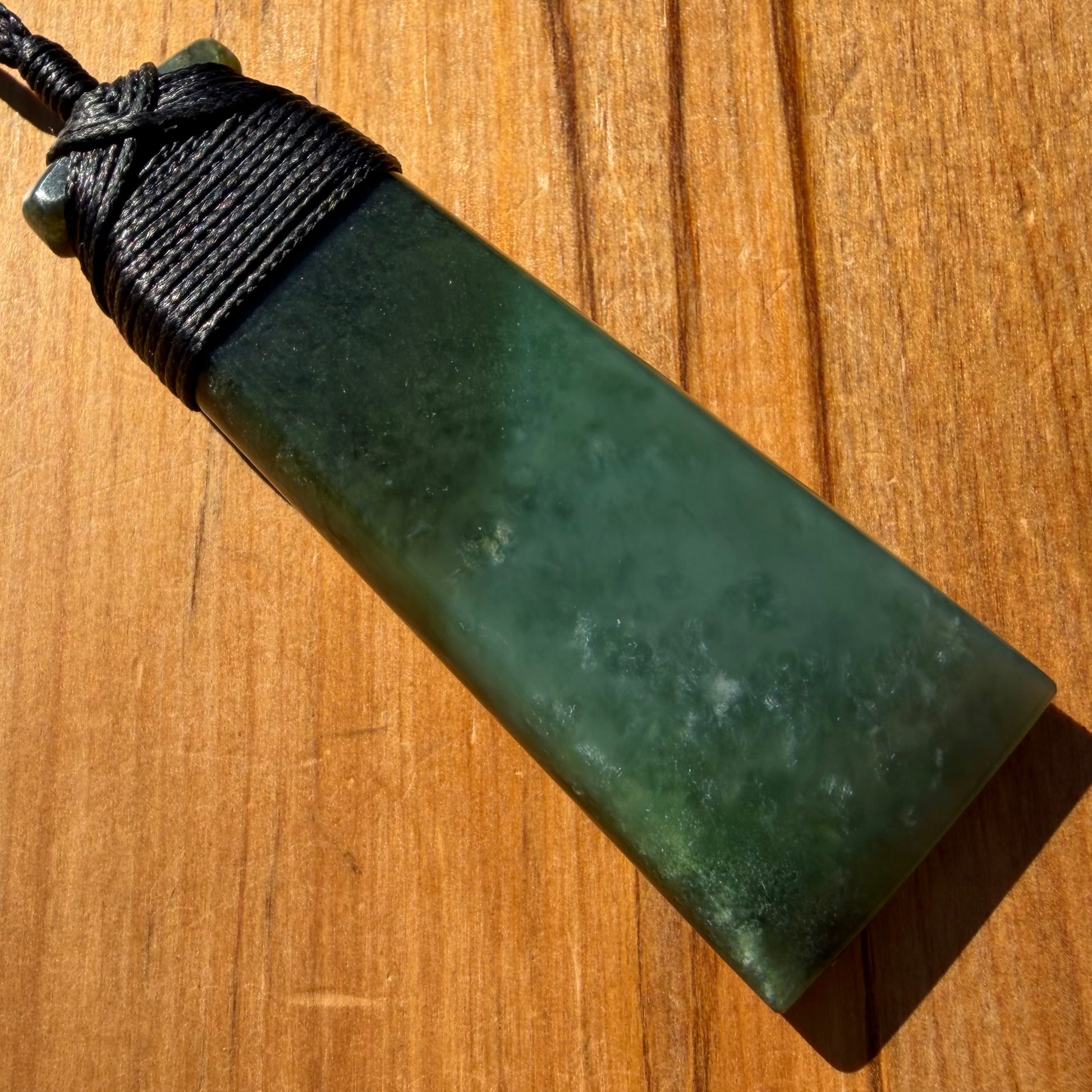 Bound toki pendant hand-carved from NZ Kahurangi pounamu (greenstone). Front.