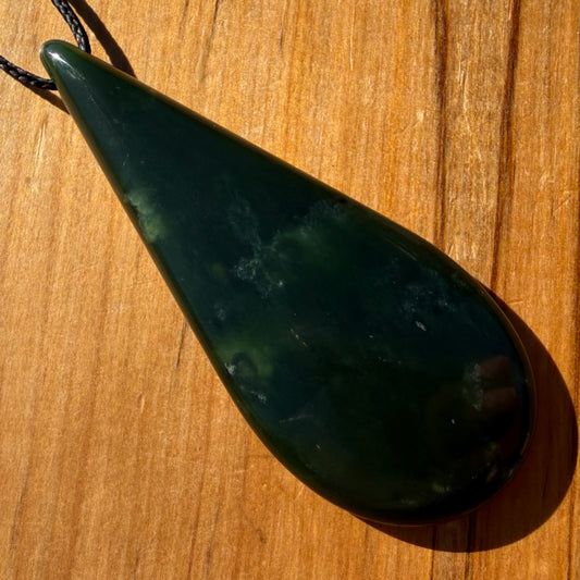 Roimata pendant hand-carved from New Zealand kawawkawa pounamu (greenstone). Front.