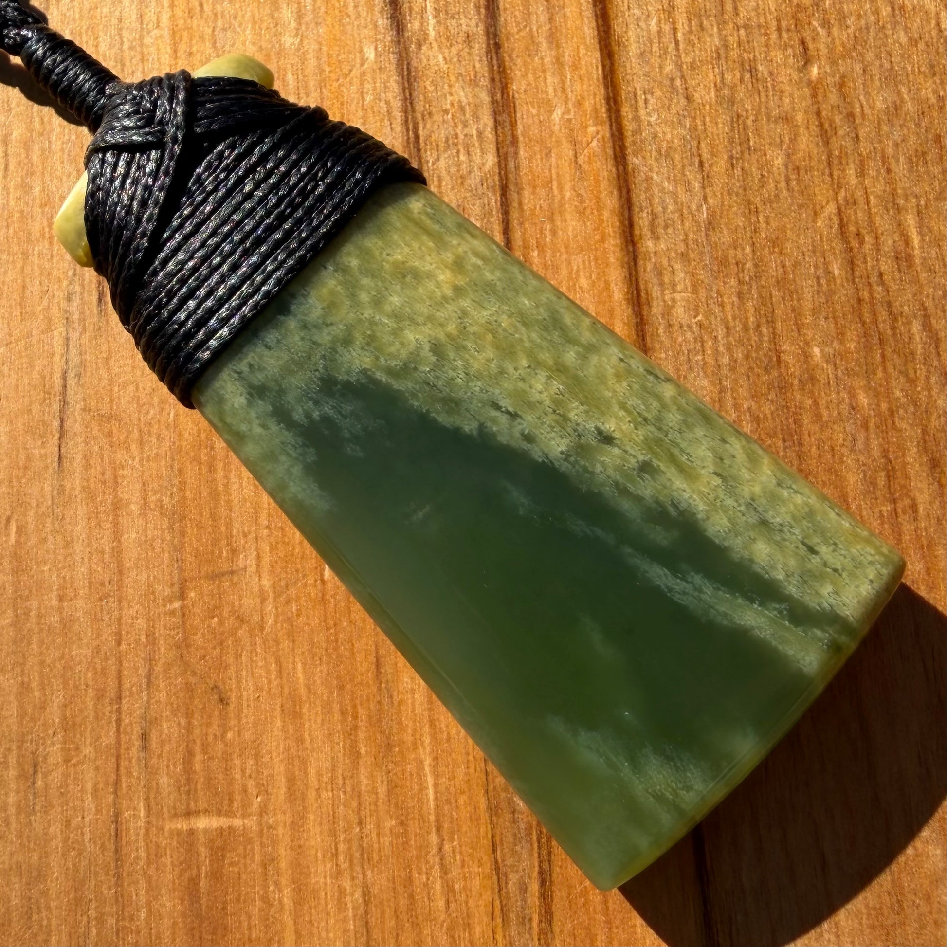 Bound pounamu toki pendant hand-carved from New Zealand Marsden Flower Jade pounamu (greenstone). Back.