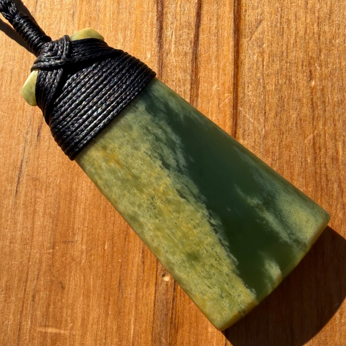 Bound pounamu toki pendant hand-carved from New Zealand Marsden Flower Jade pounamu (greenstone). Front.