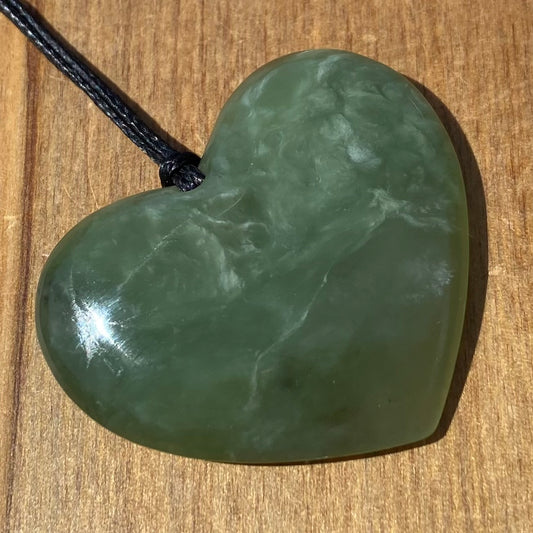 Heart necklace hand-carved from New Zealand pounamu (greenstone) Kahurangi. Front.