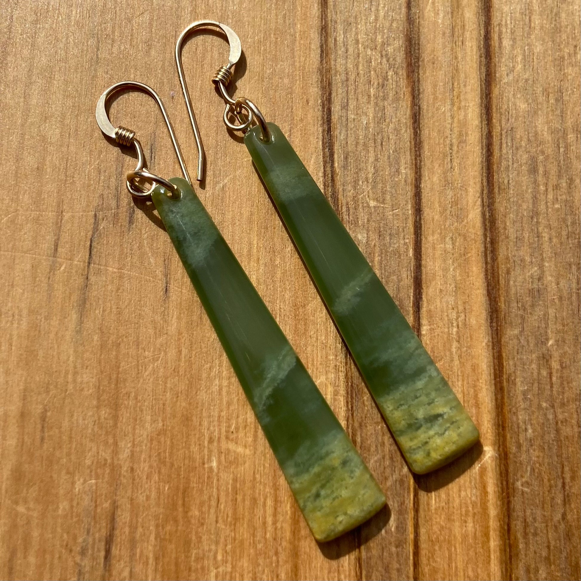 Pair of  toki earrings hand-carved from New Zealand Marsden Flower Jade/ pounamu (greenstone), with gold  fittings. Front.