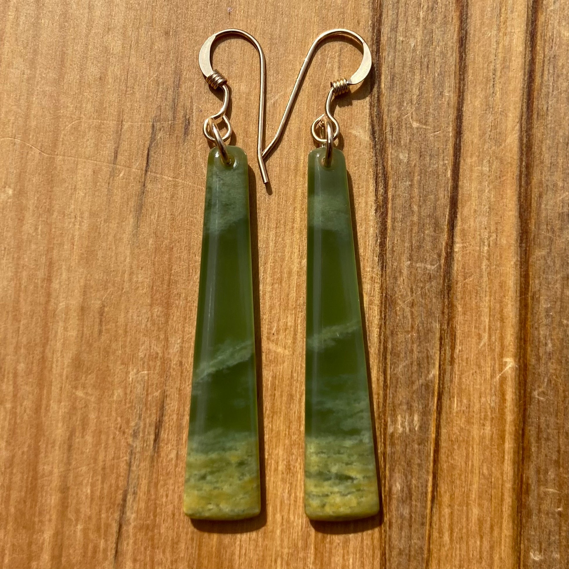 Pair of  toki earrings hand-carved from New Zealand Marsden Flower Jade/ pounamu (greenstone), with gold  fittings. Front.