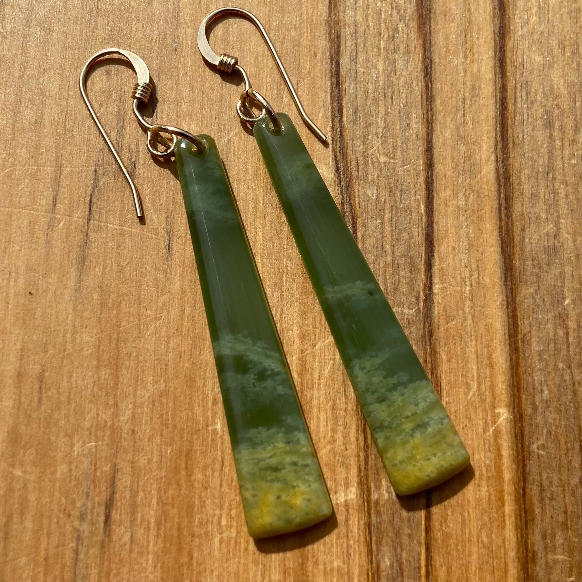Pair of  toki earrings hand-carved from New Zealand Marsden Flower Jade/ pounamu (greenstone), with gold  fittings. Front.
