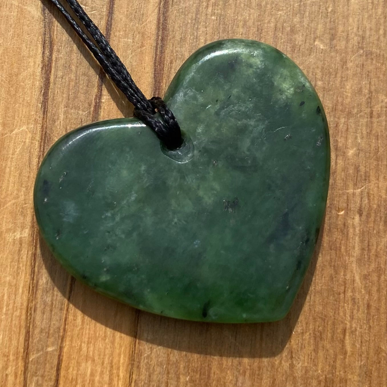 Heart necklace hand-carved from NZ kawakawa pounamu (greenstone).  Back.