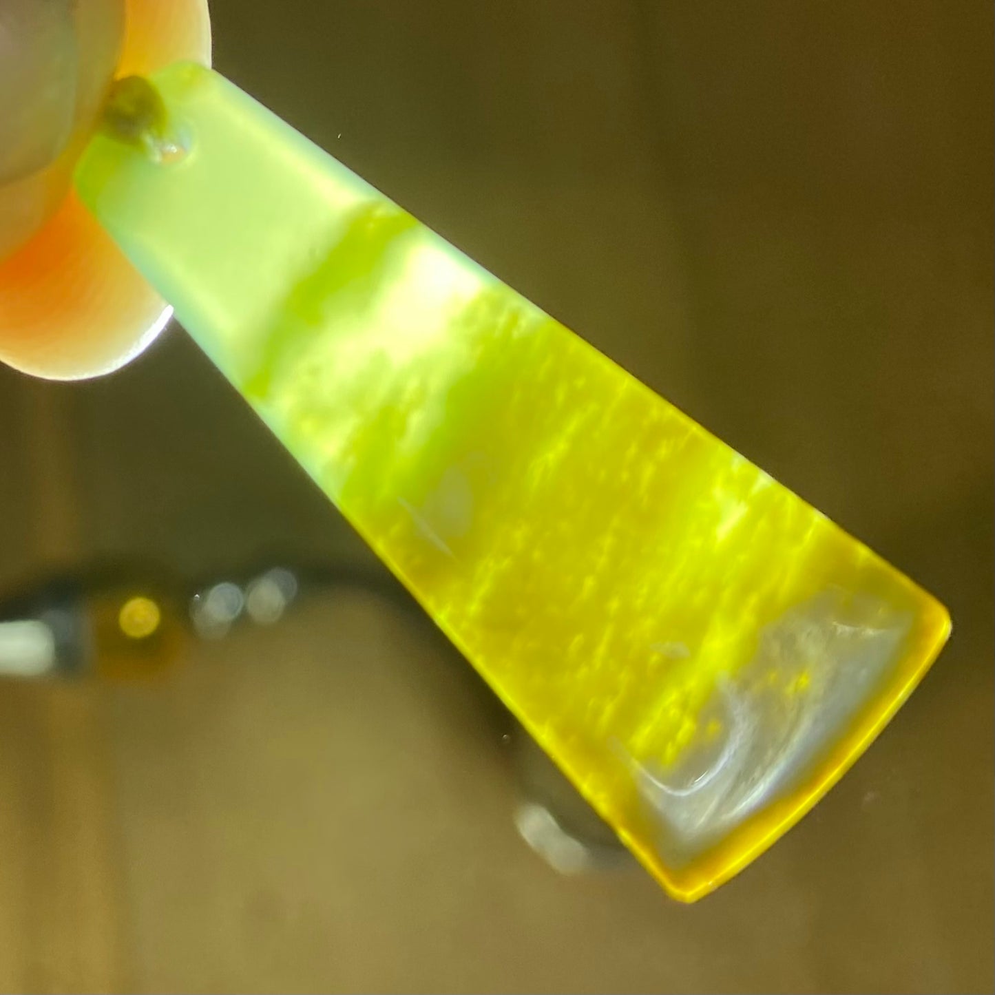 Pounamu toki pendant hand-carved from New Zealand Marsden Flower Jade pounamu (greenstone). Translucency.