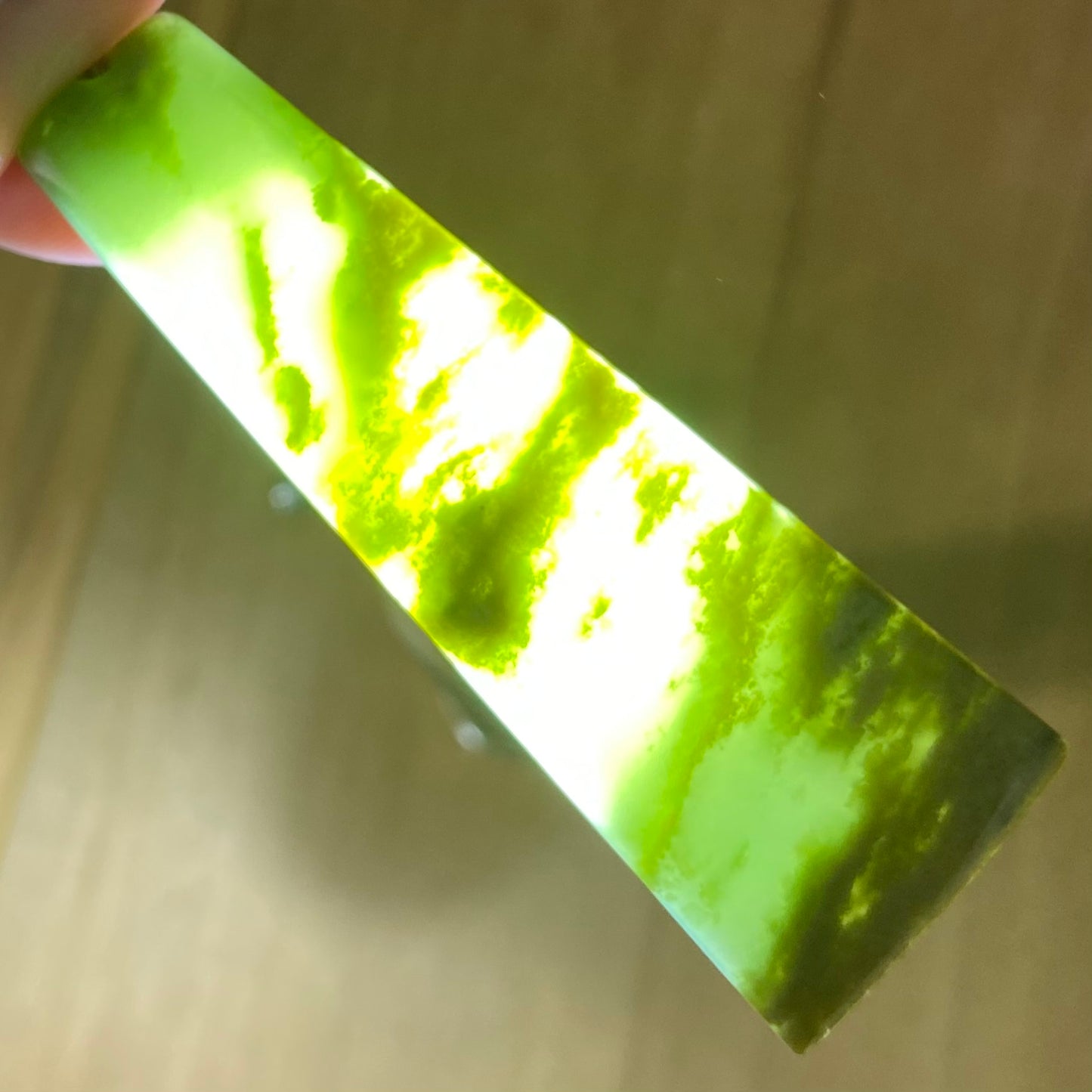 Pounamu toki pendant hand-carved from New Zealand Marsden Flower Jade pounamu (greenstone). Translucency.