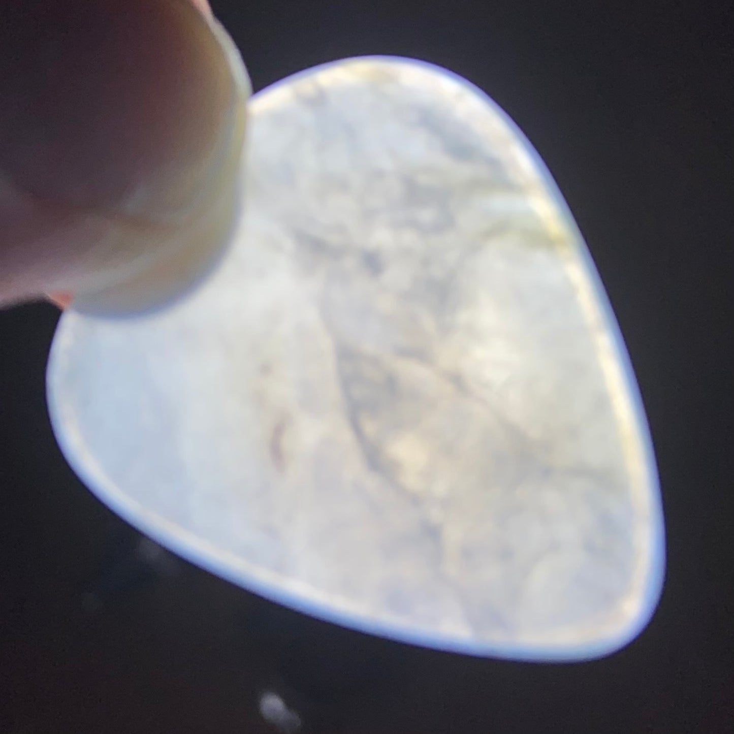 Guitar pick hand-carved from New Zealand Inanga Greenstone pounamu (greenstone). Translucency. 