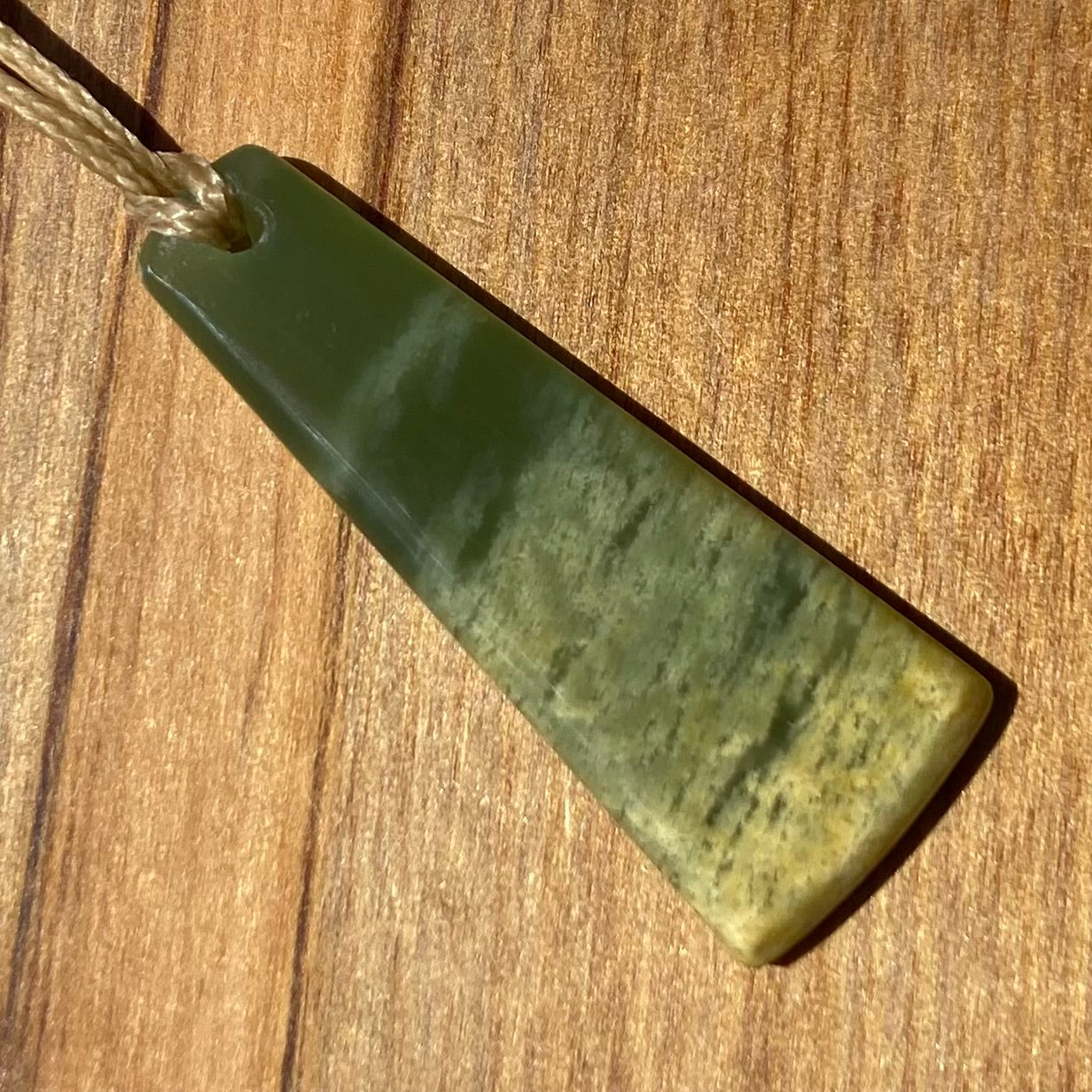 Pounamu toki pendant hand-carved from New Zealand Marsden Flower Jade pounamu (greenstone).