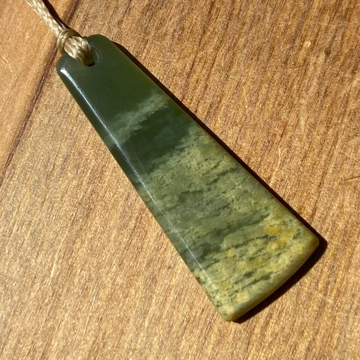 Pounamu toki pendant hand-carved from New Zealand Marsden Flower Jade pounamu (greenstone). Front