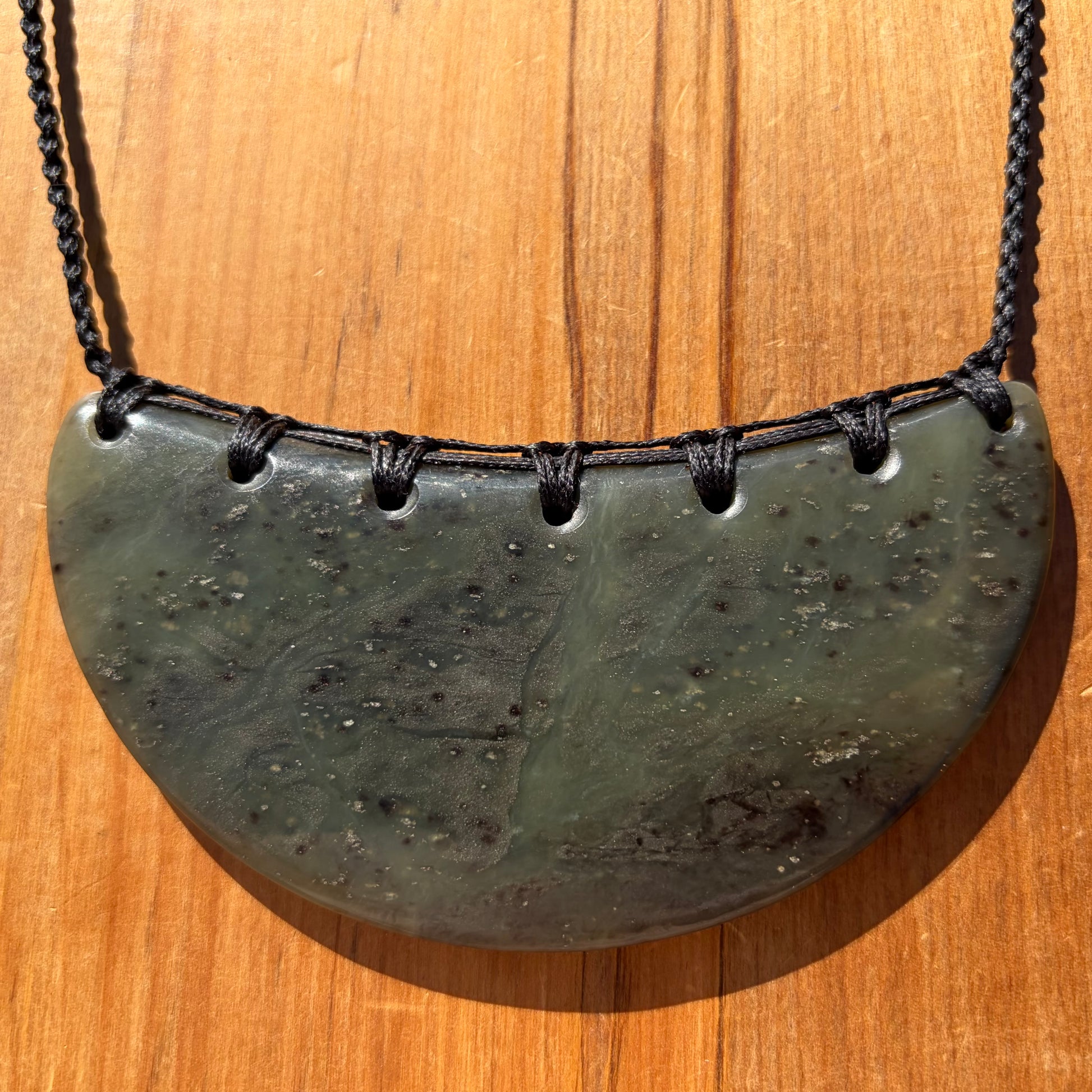 Breastplate pendant hand-carved from New Zealand kawakawa pounamu (greenstone). Front.
