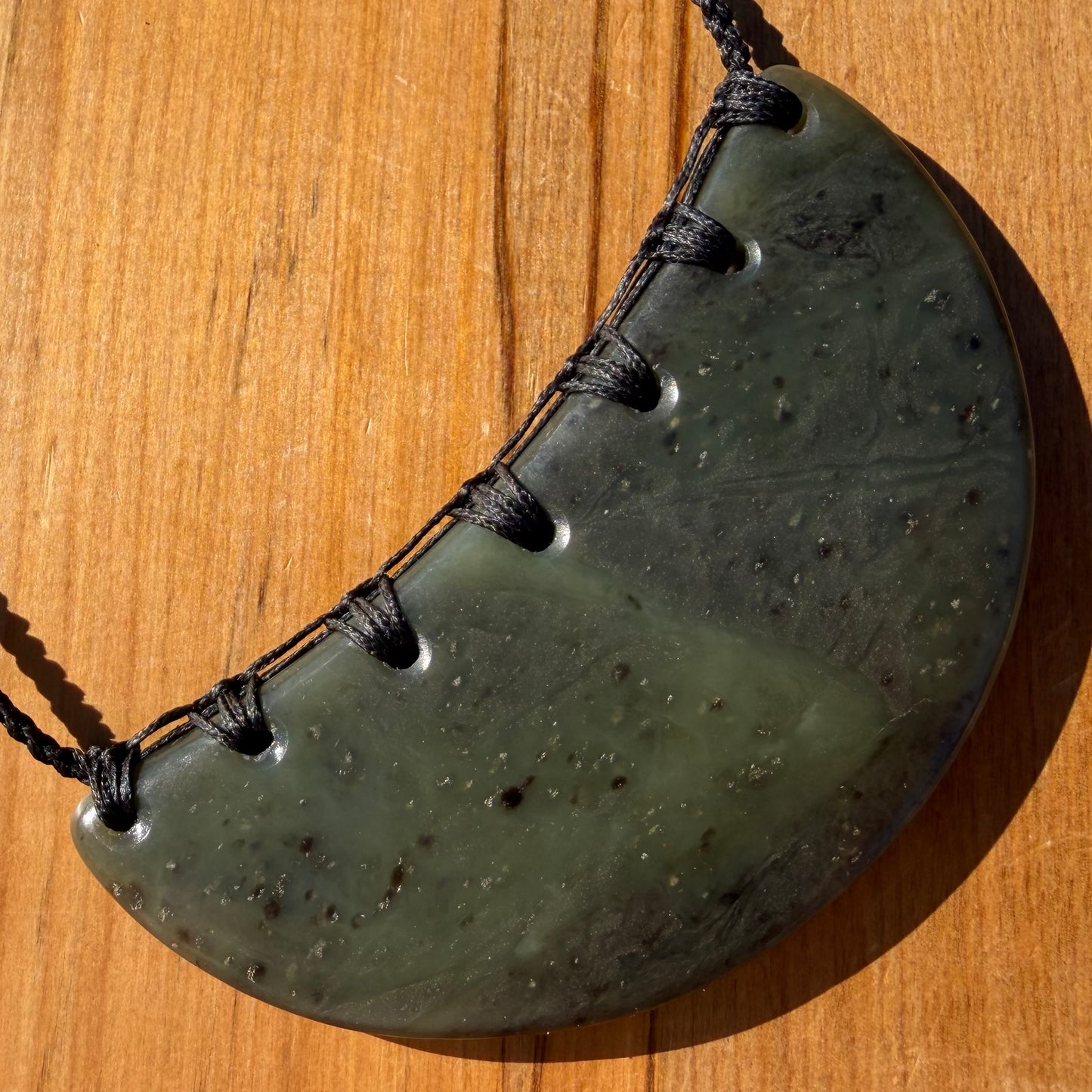 Breastplate pendant hand-carved from New Zealand kawakawa pounamu (greenstone). Front.