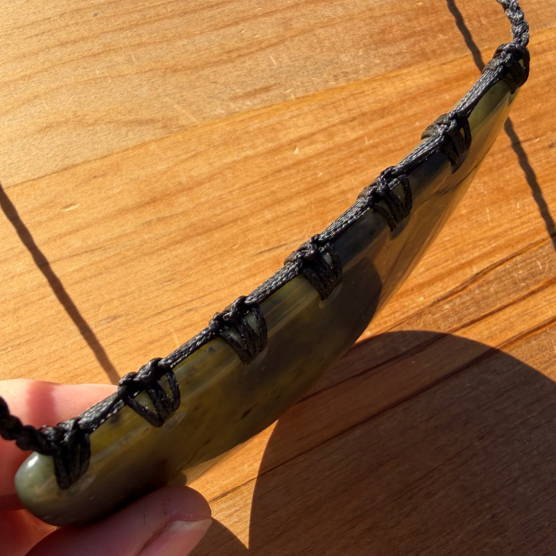 Breastplate pendant hand-carved from New Zealand kawakawa pounamu (greenstone). Binding.