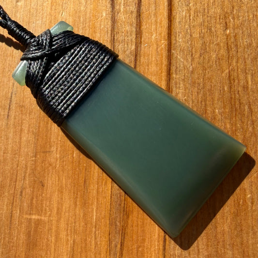 Bound toki pendant hand-carved from New Zealand inanga pounamu (greenstone). Front.