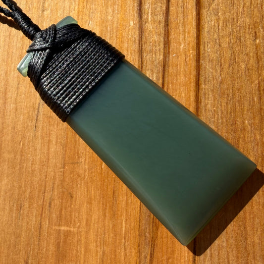 Bound toki pendant hand-carved from New Zealand inanga pounamu (greenstone). Front.