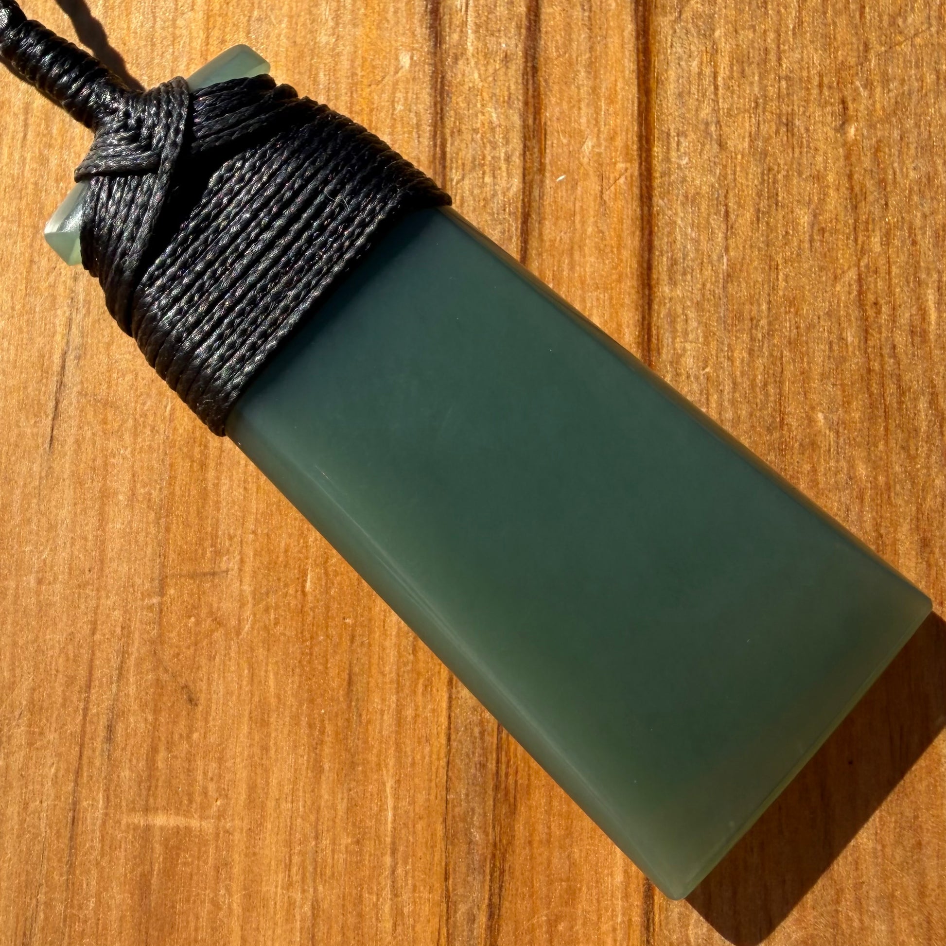 Bound toki pendant hand-carved from New Zealand inanga pounamu (greenstone). Back.