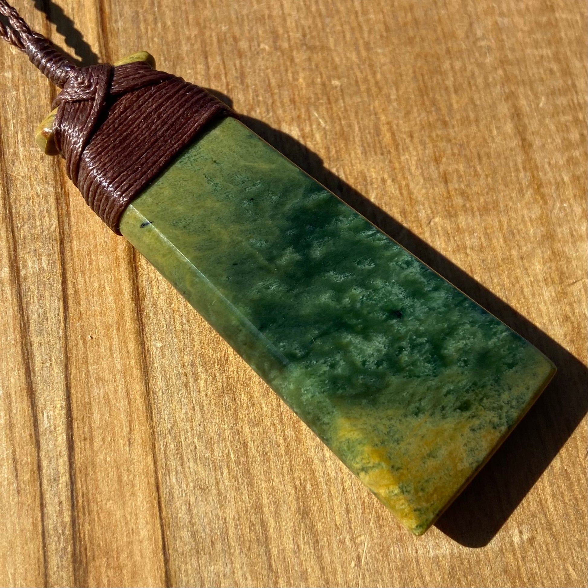Bound pounamu toki pendant hand-carved from New Zealand Marsden Flower Jade pounamu (greenstone). Back.