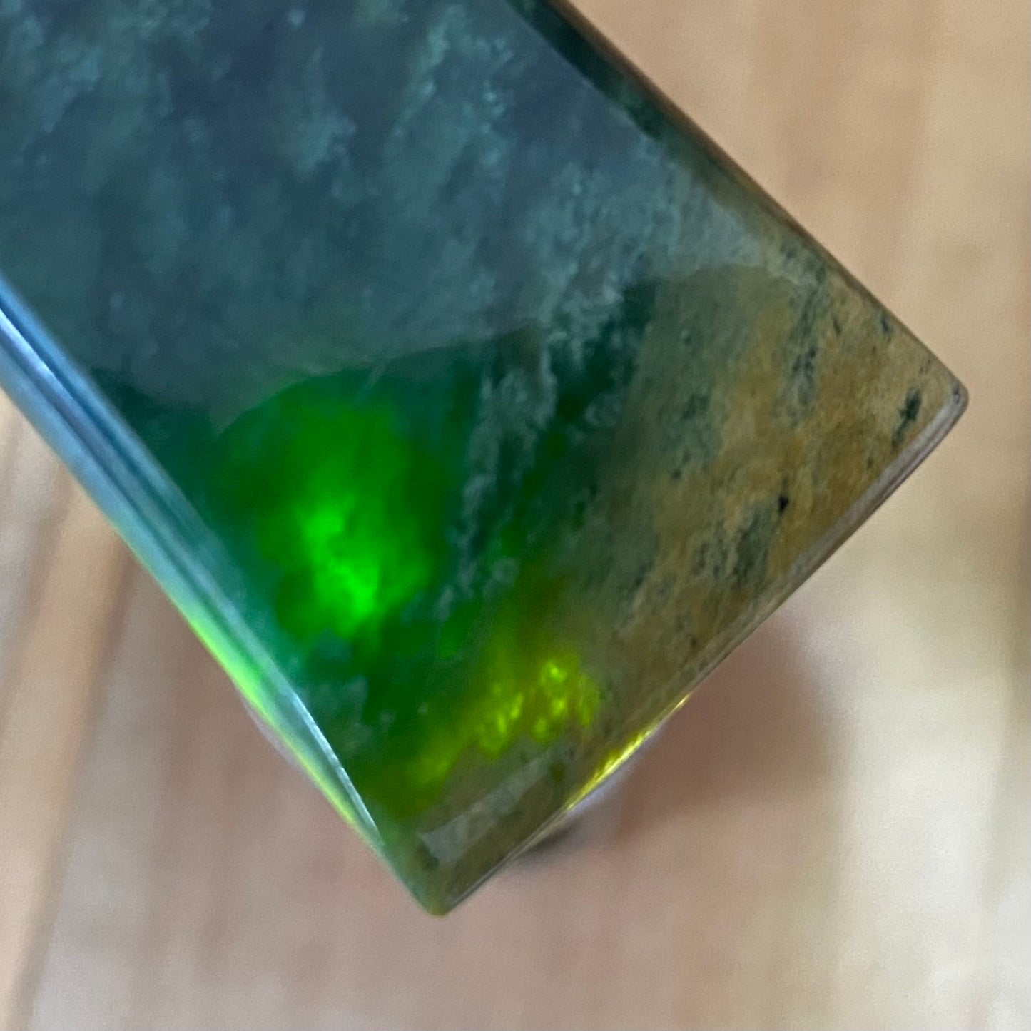 Bound pounamu toki pendant hand-carved from New Zealand Marsden Flower Jade pounamu (greenstone). Translucency.