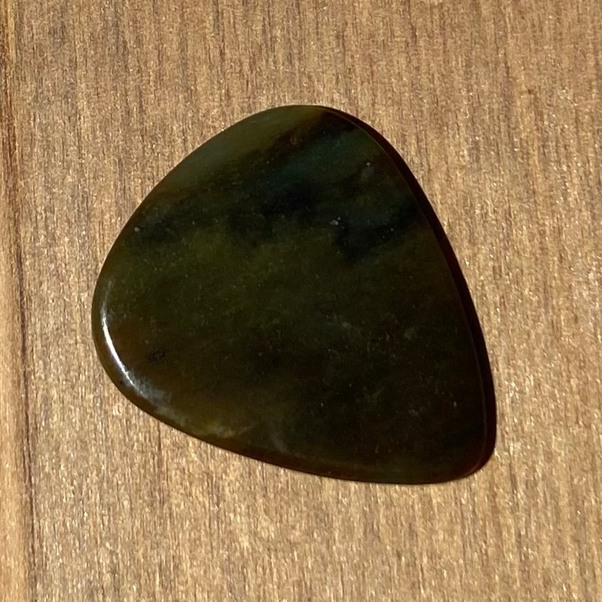 Guitar pick hand-carved from New Zealand Kawakawa Greenstone pounamu (greenstone). Back. 