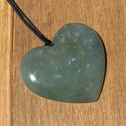 Heart shaped pendant hand-carved from New Zealand inanga pounamu (greenstone). Front.