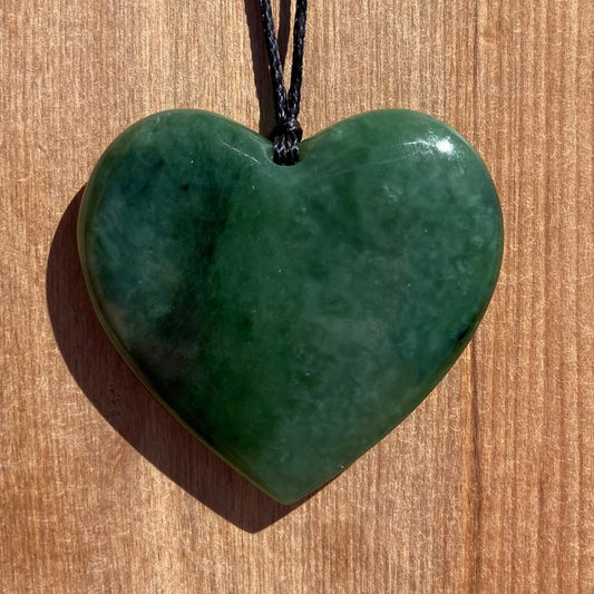 Heart pendant hand-carved from New Zealand kahurangi pounamu (greenstone). Front.