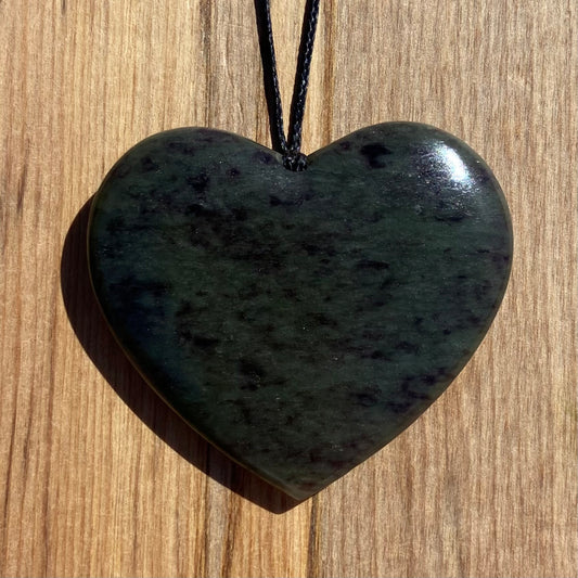 Heart pendant hand-carved from New Zealand totoweka pounamu (greenstone). Front.