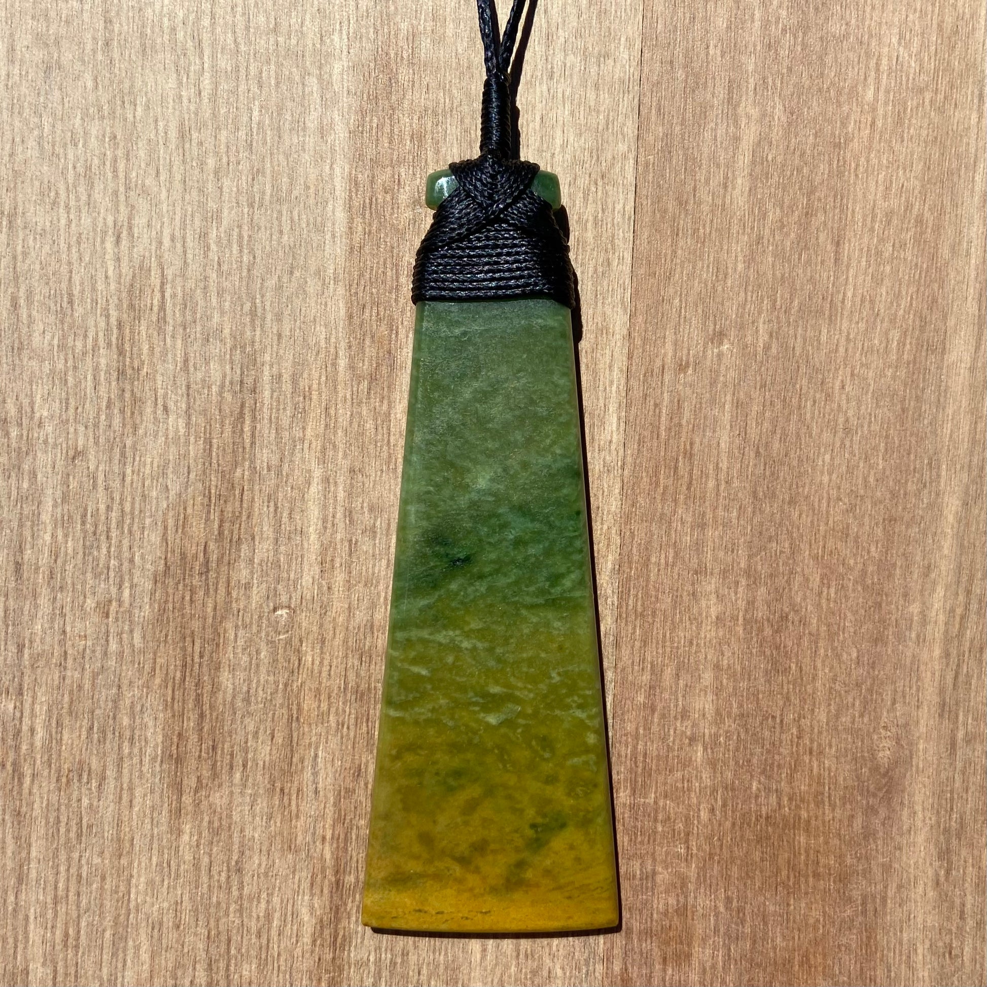 Toki pendant hand-carved from New Zealand Marsden Flower Jade/ pounamu (greenstone). Back.