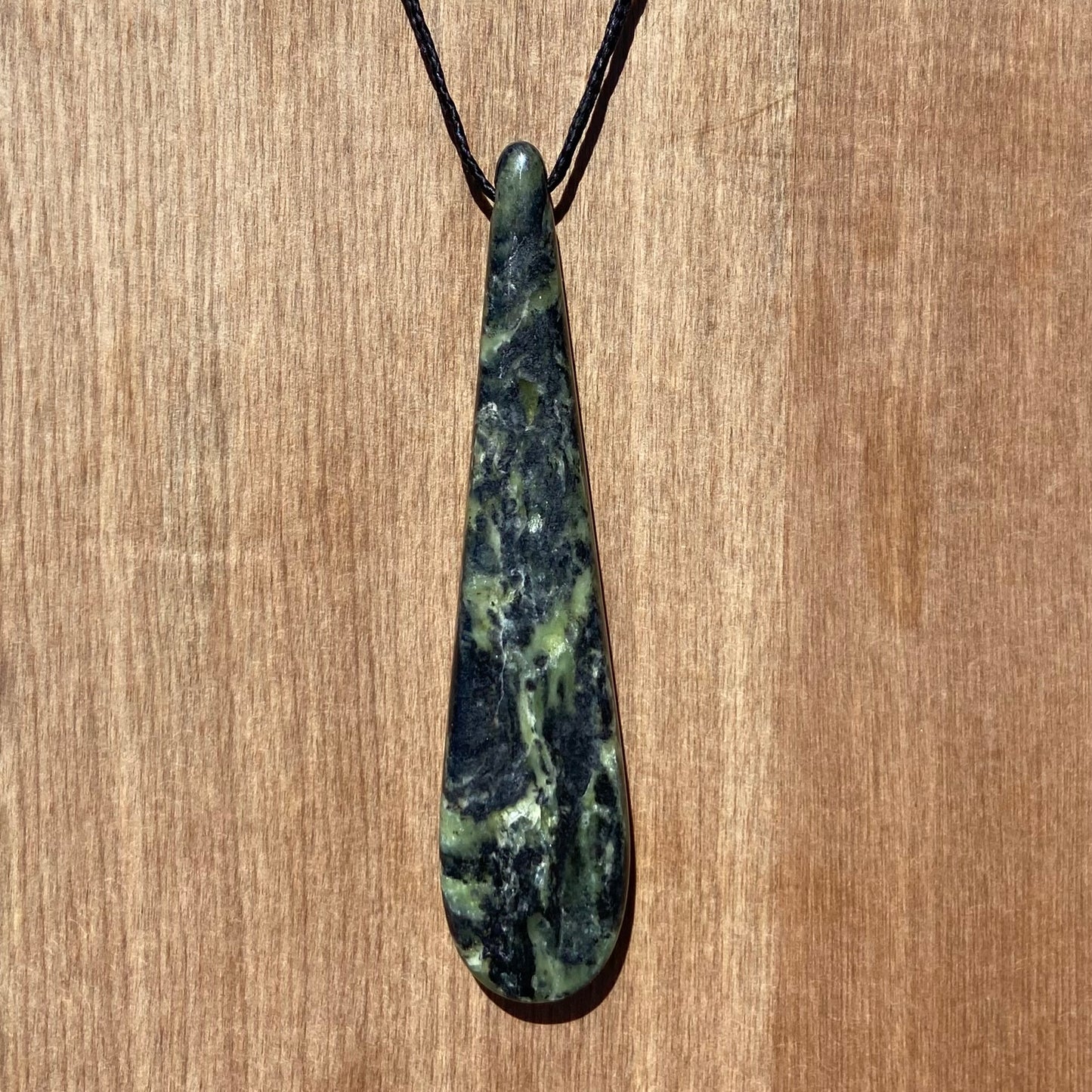 Roimata (teardrop) pendant hand-carved from New Zealand Douglas Creek pounamu (greenstone). Front.