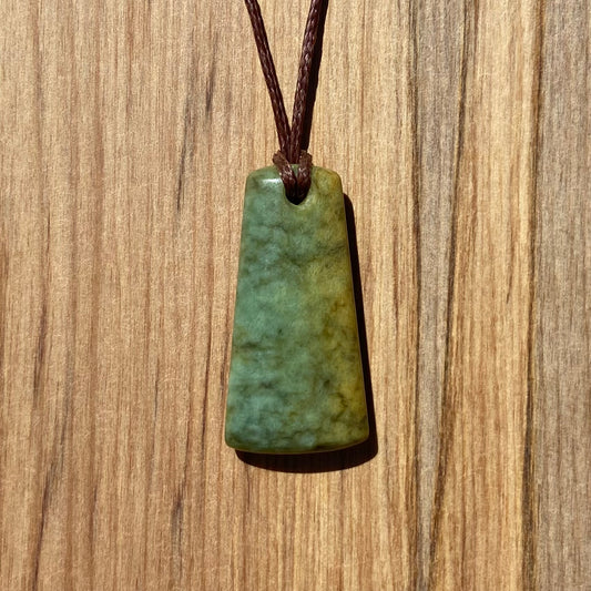 Toki pendant hand-carved from New Zealand flower jade/ pounamu (greenstone). Front.