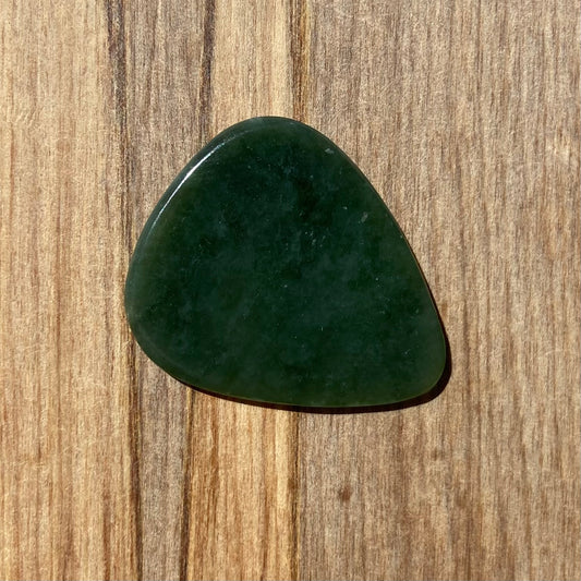Guitar pick hand-carved from New Zealand kahurangi pounamu (greenstone). Front.