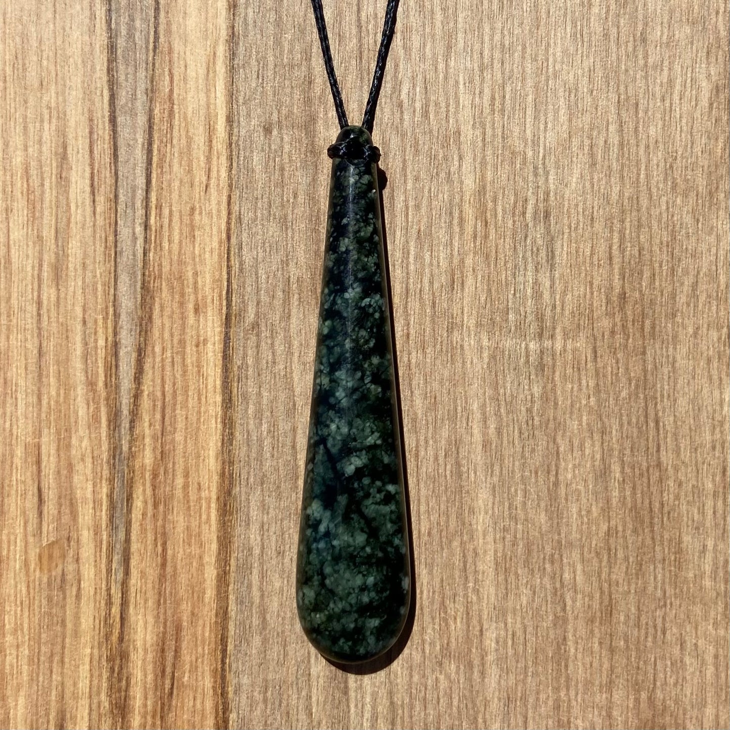 Roimata (teardrop) pendant hand-carved from New Zealand tangiwai pounamu (greenstone). Front.