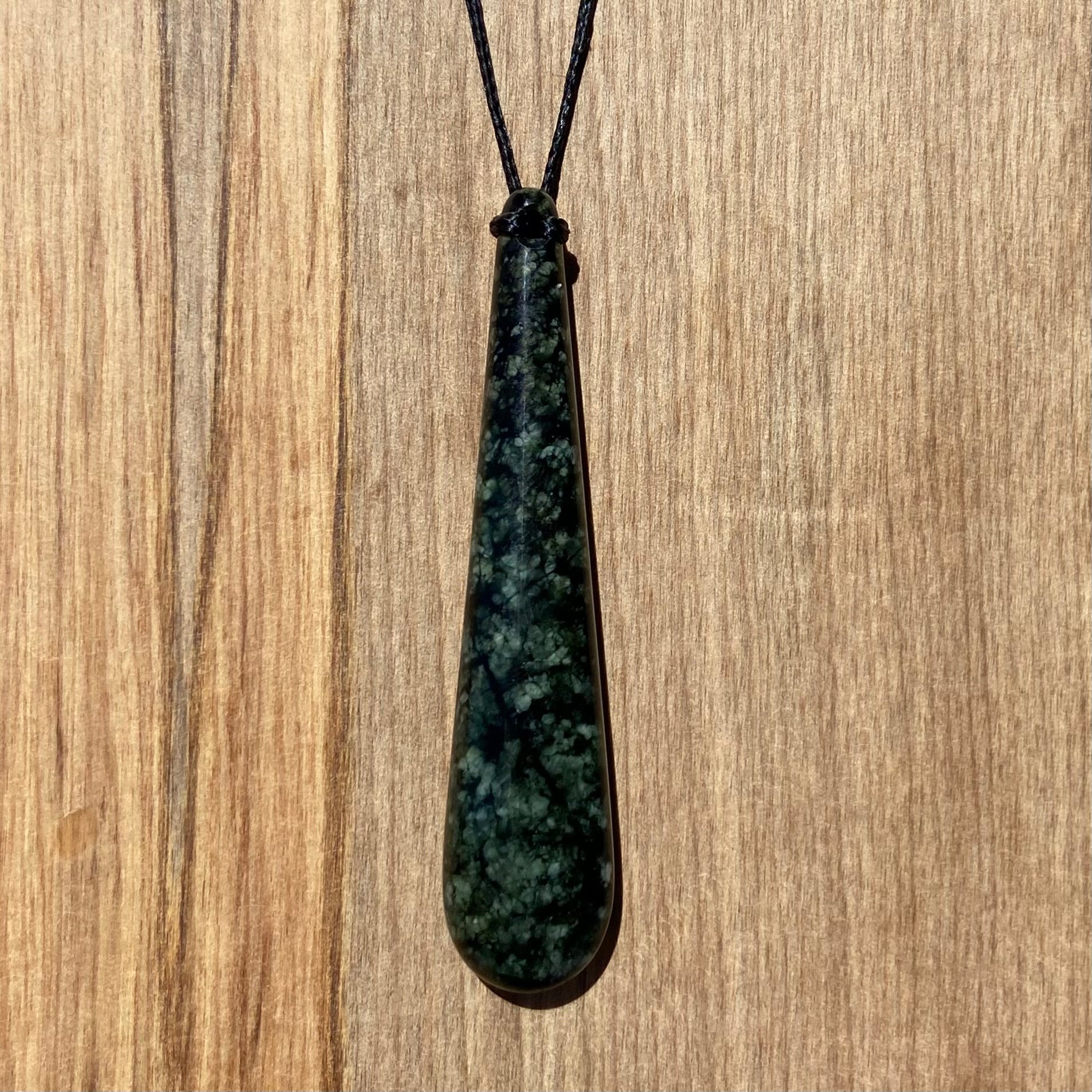 Roimata (teardrop) pendant hand-carved from New Zealand tangiwai pounamu (greenstone). Front.