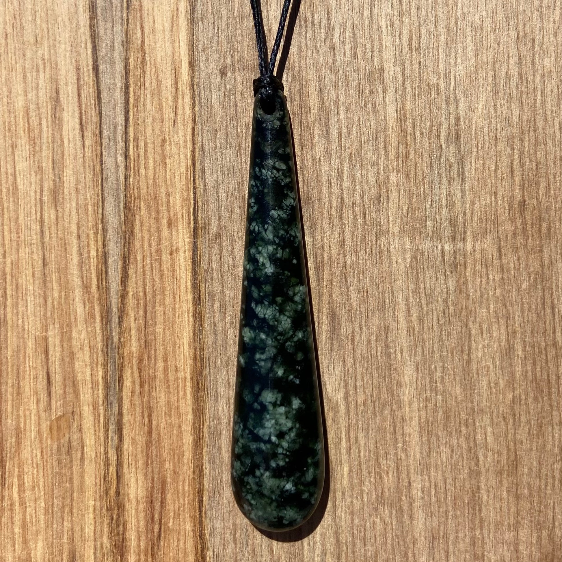 Roimata (teardrop) pendant hand-carved from New Zealand tangiwai pounamu (greenstone). Back.