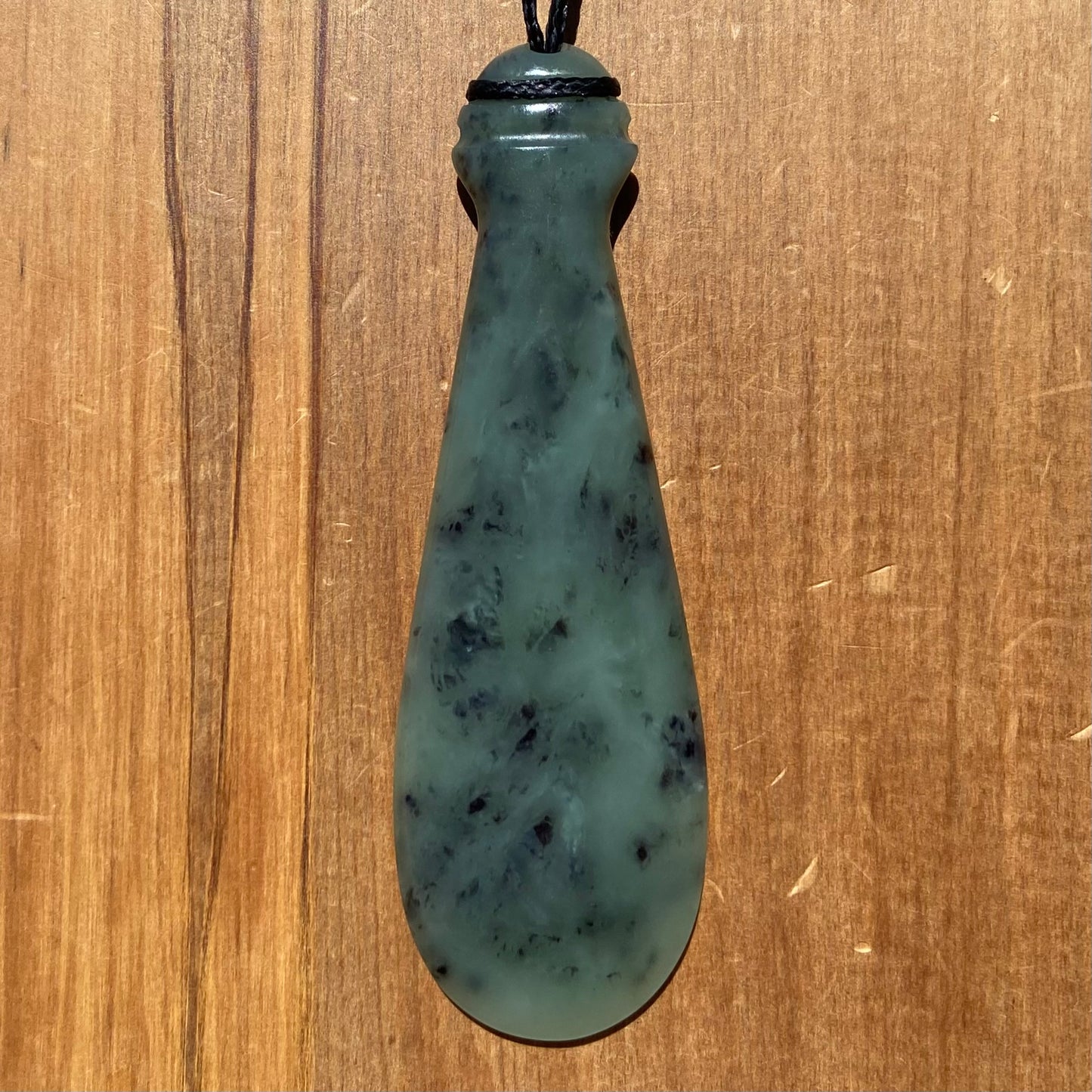 Mere pendant hand-carved from New Zealand inanga pounamu (greenstone). Front.