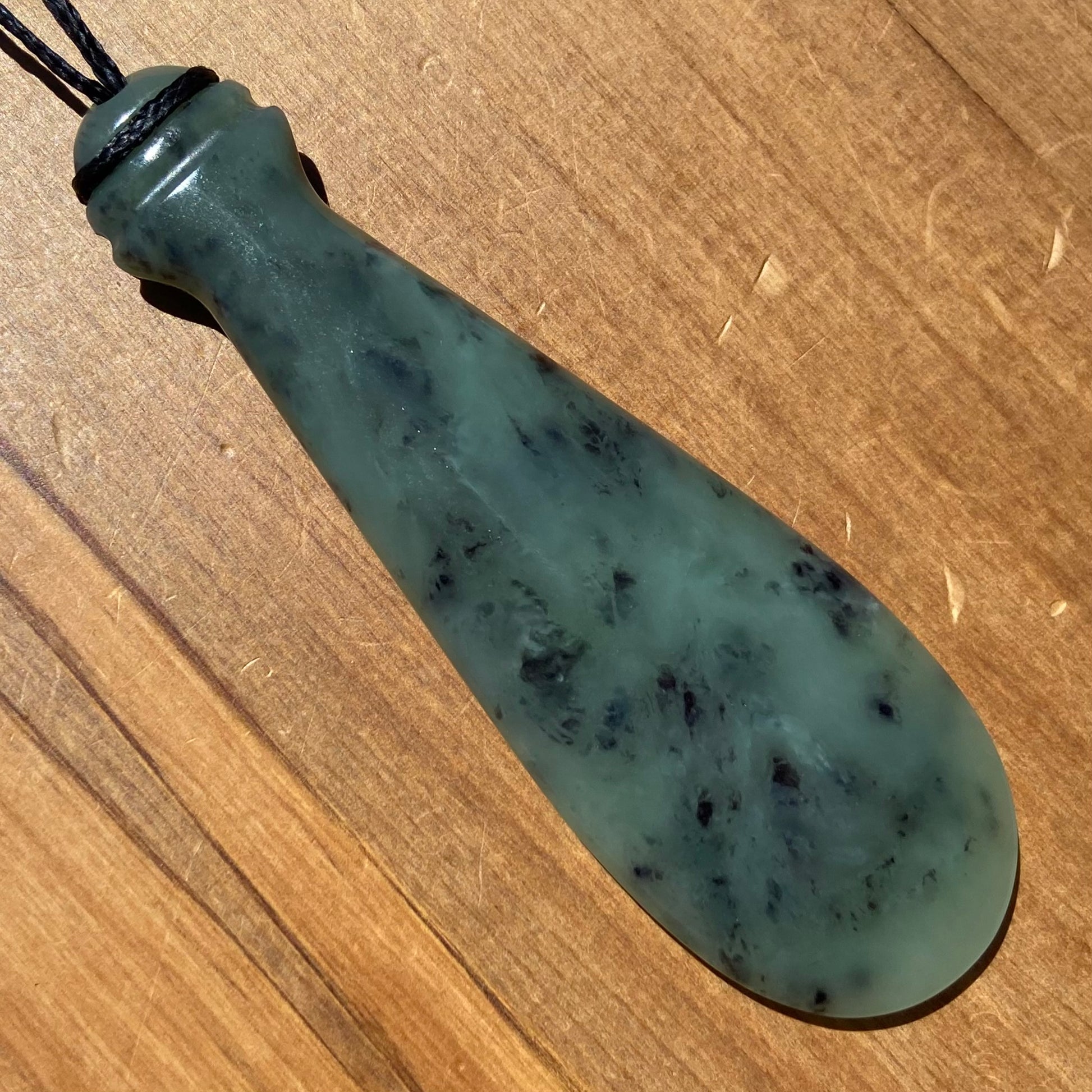 Mere pendant hand-carved from New Zealand inanga pounamu (greenstone). Front.
