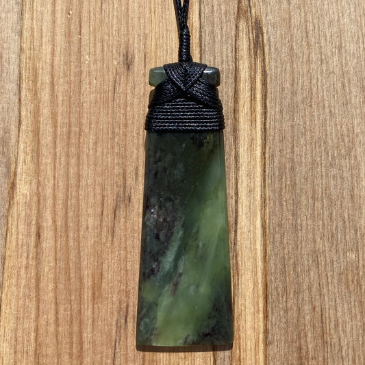 Bound toki pendant hand-carved from New Zealand totoweka pounamu (greenstone). Front.