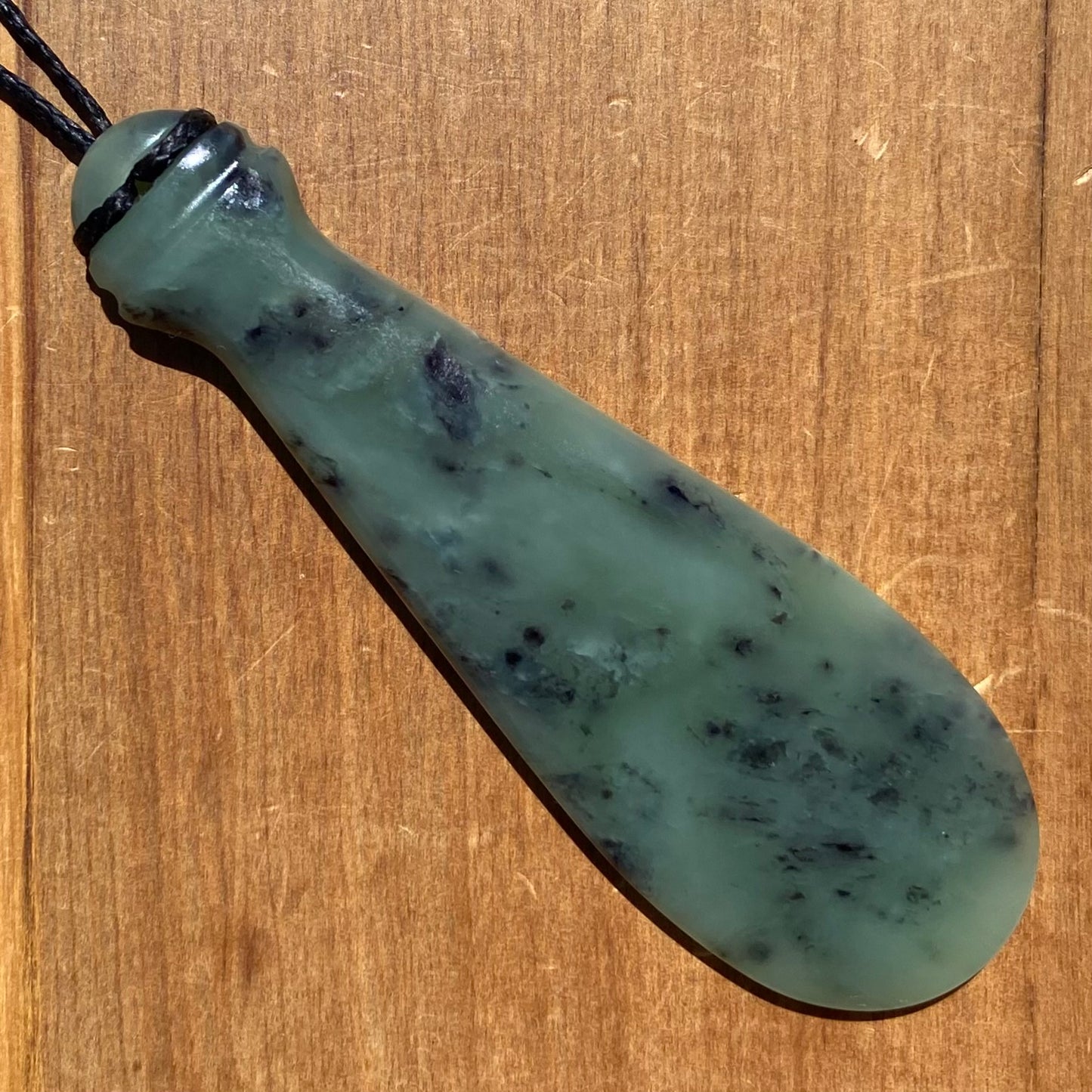 Mere pendant hand-carved from New Zealand inanga pounamu (greenstone). Back.