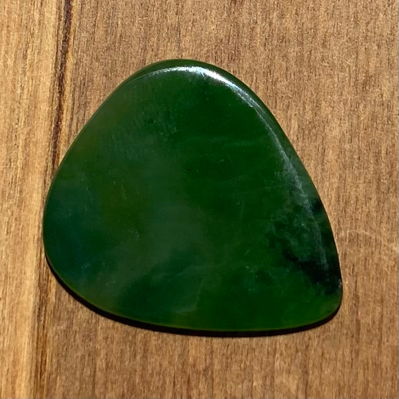 Guitar pick hand-carved from New Zealand Kahurangi Greenstone pounamu (greenstone). Back.