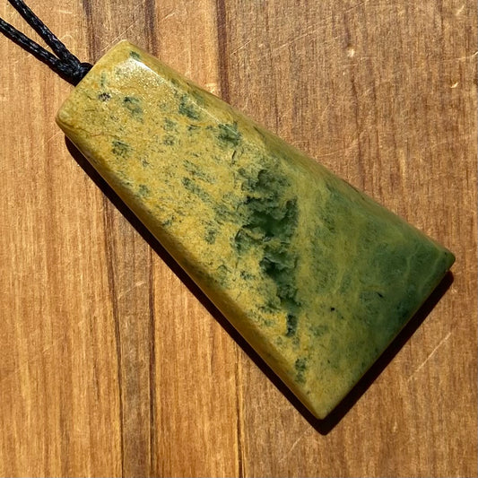 Pounamu toki pendant hand-carved from New Zealand Marsden Flower Jade pounamu (greenstone). Front.