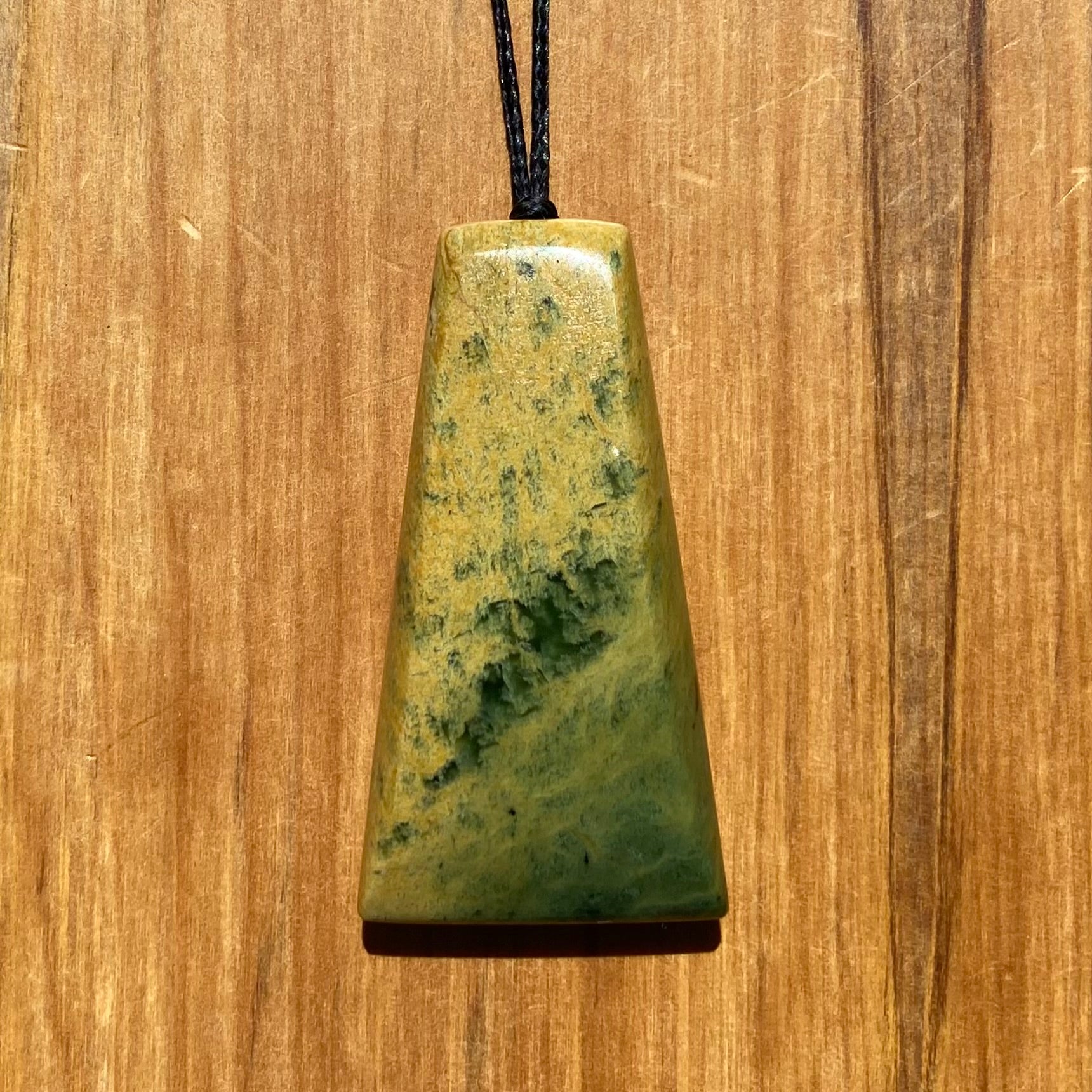 Pounamu toki pendant hand-carved from New Zealand Marsden Flower Jade pounamu (greenstone). Front.