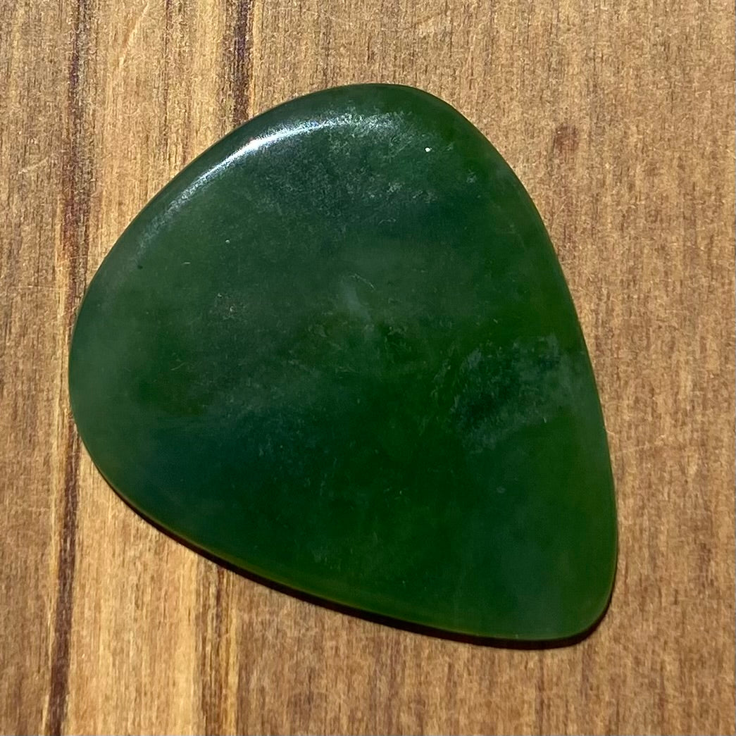 Guitar pick hand-carved from New Zealand Kahurangi Greenstone pounamu (greenstone). Back.