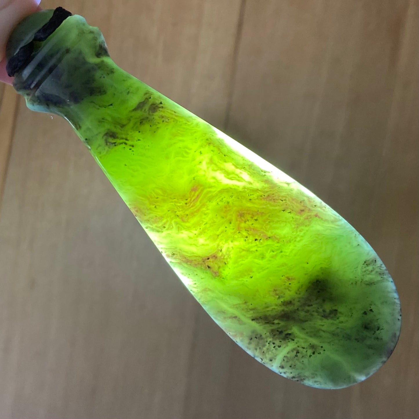 Mere pendant hand-carved from New Zealand Kawakawa pounamu (greenstone). Translucency.