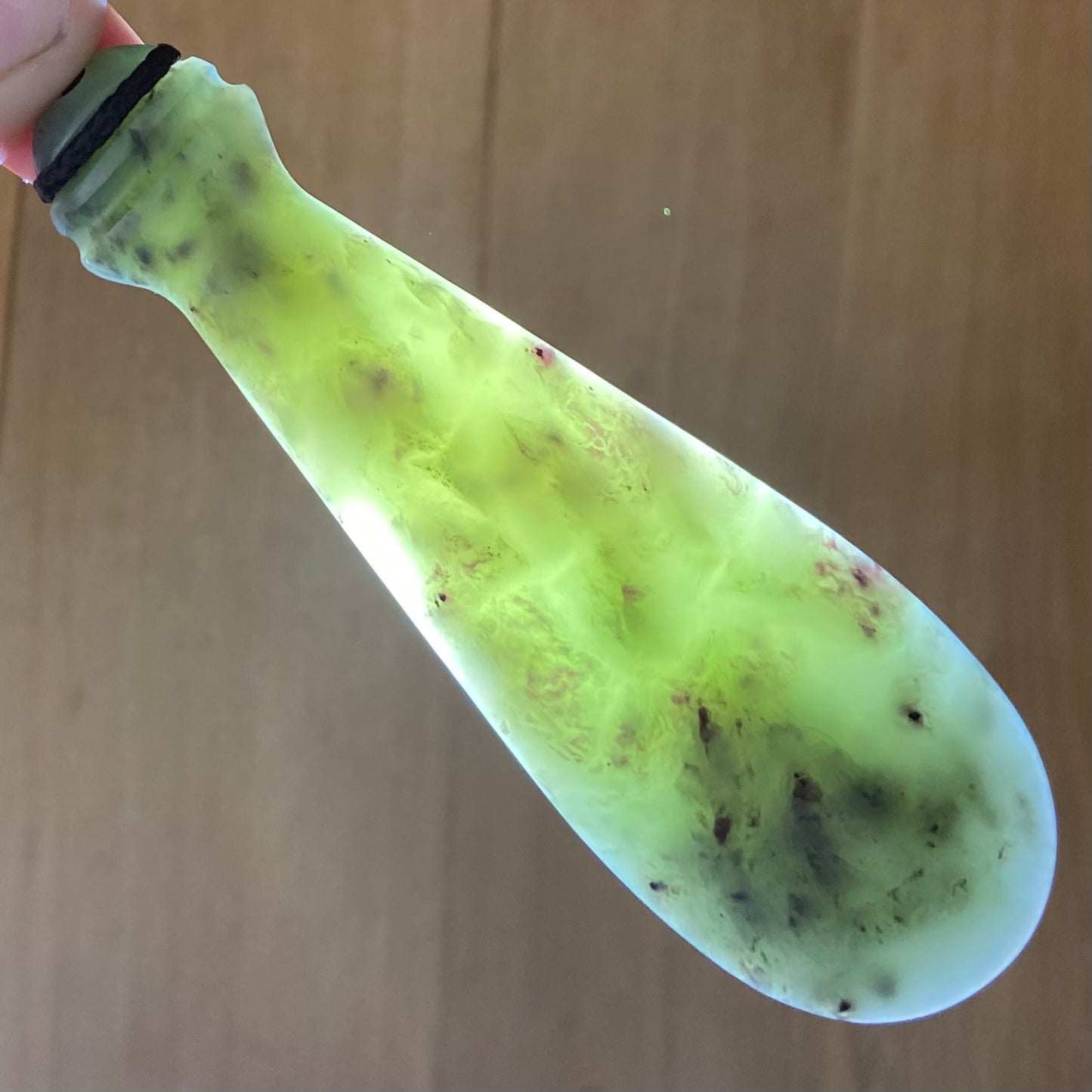 Mere pendant hand-carved from New Zealand inanga pounamu (greenstone). Translucency.