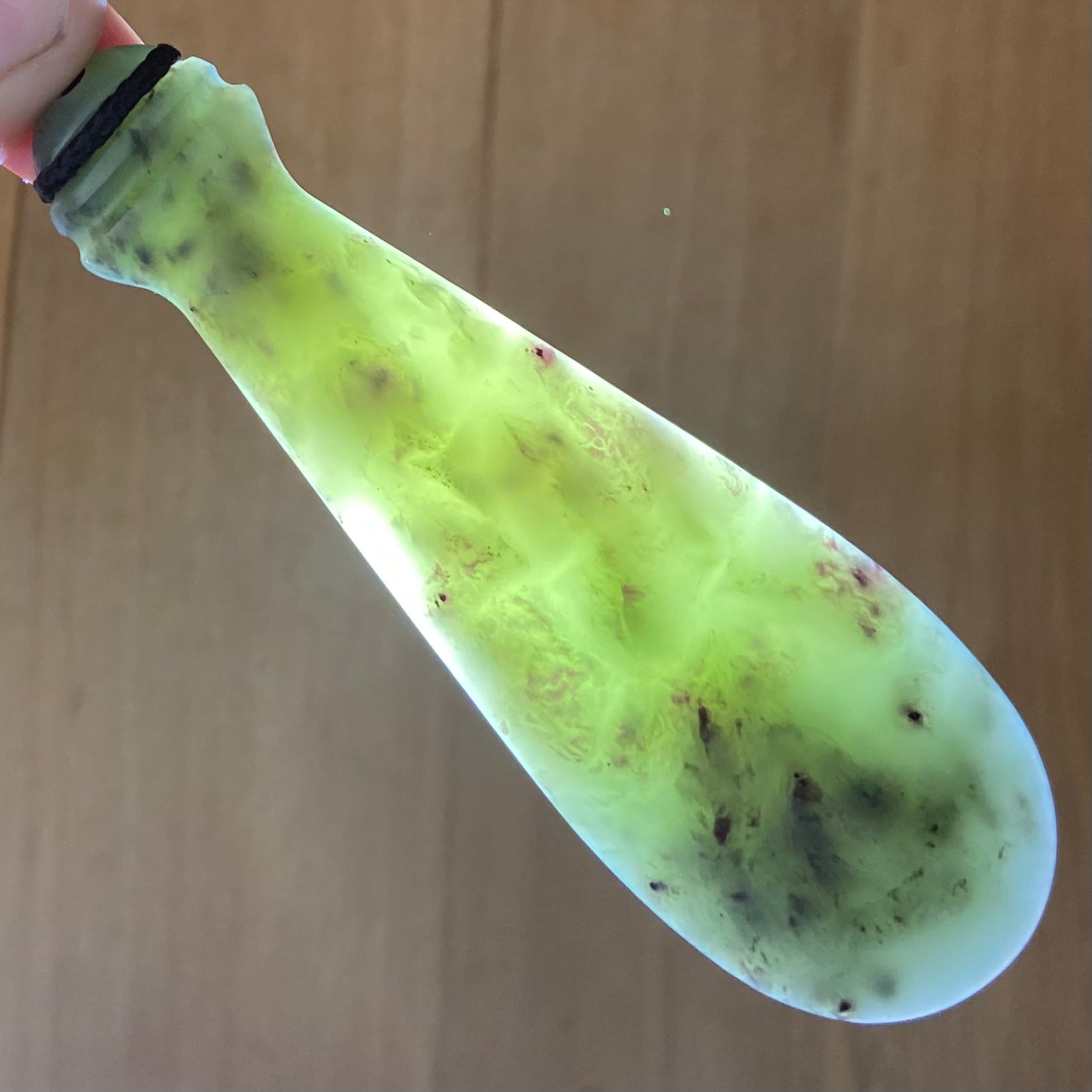 Mere pendant hand-carved from New Zealand inanga pounamu (greenstone). Translucency.