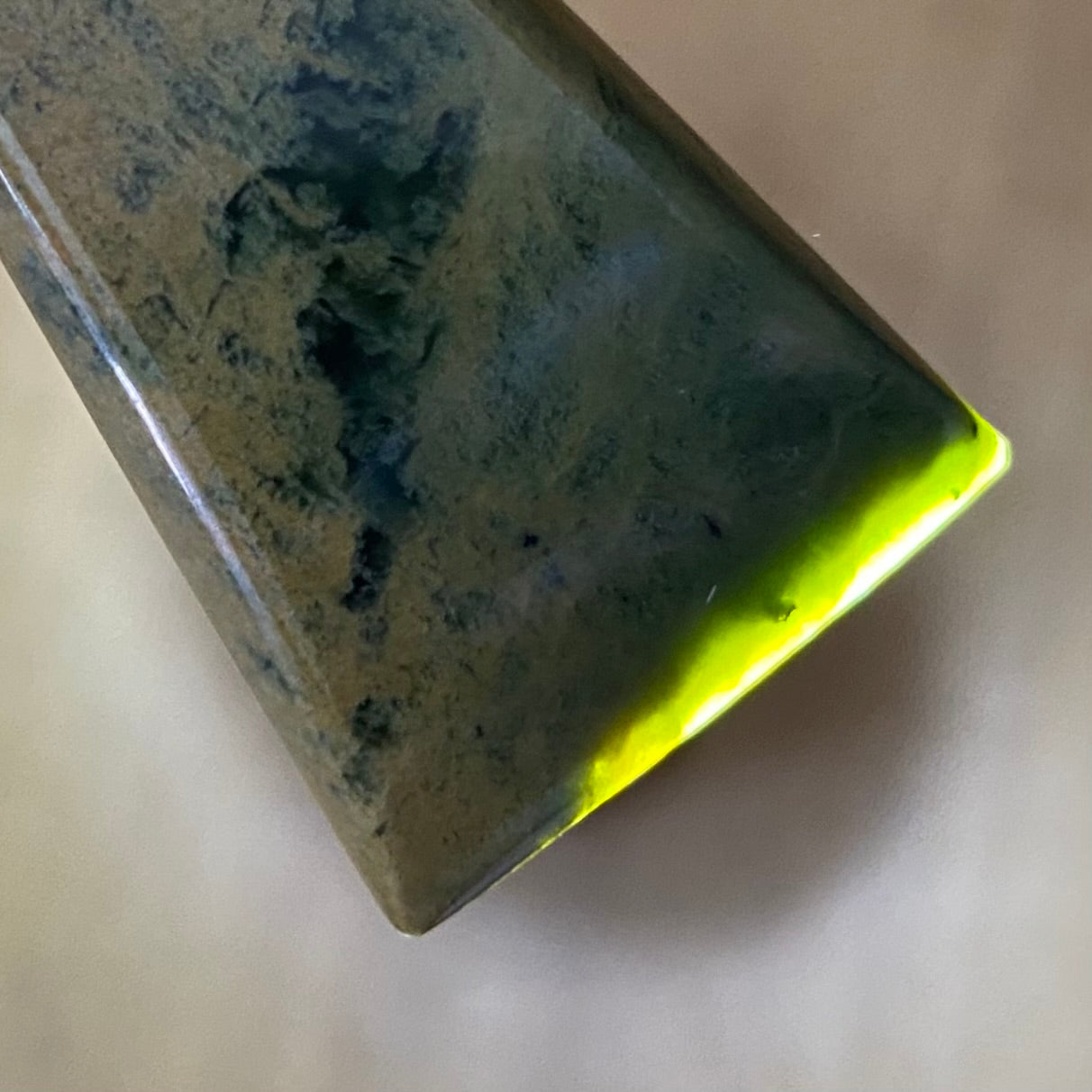 Pounamu toki pendant hand-carved from New Zealand Marsden Flower Jade pounamu (greenstone). Translucency.