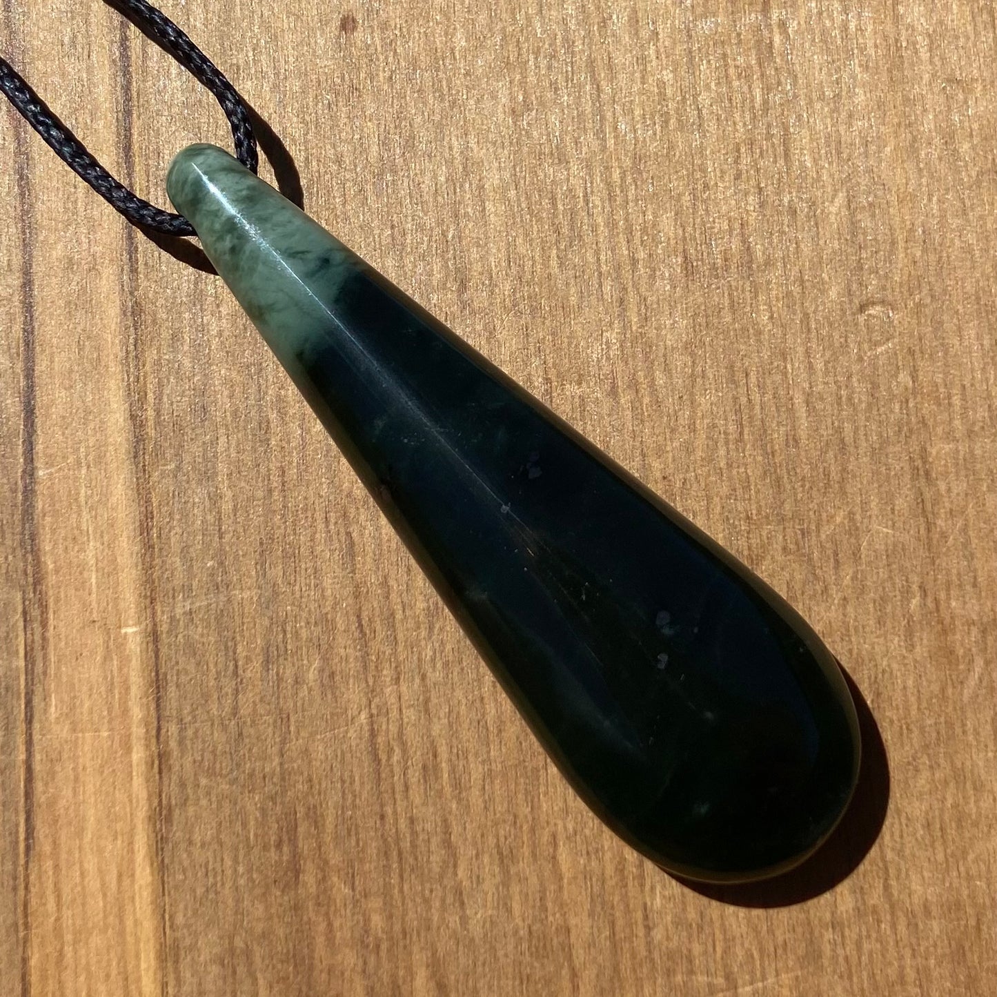 Toki pendant hand-carved from New Zealand kawawkawa pounamu (greenstone). Front.