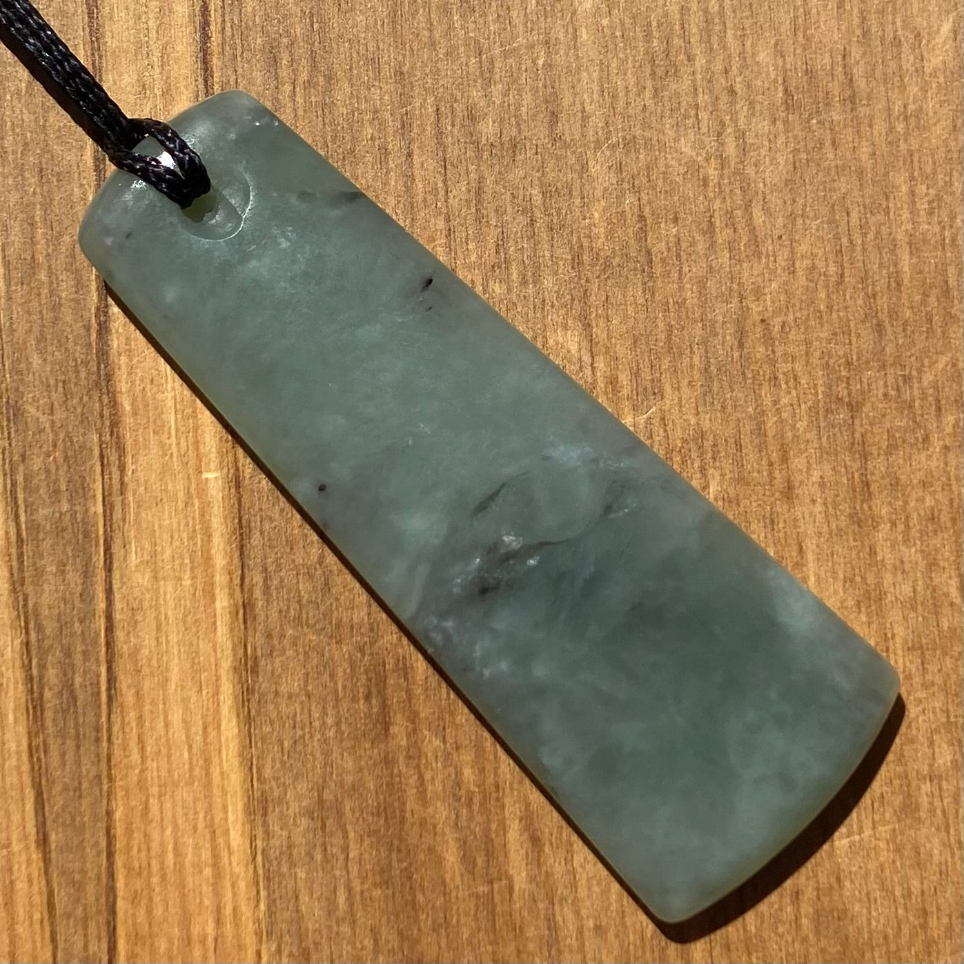 Toki pendant hand-carved from New Zealand inanga pounamu (greenstone). Back.