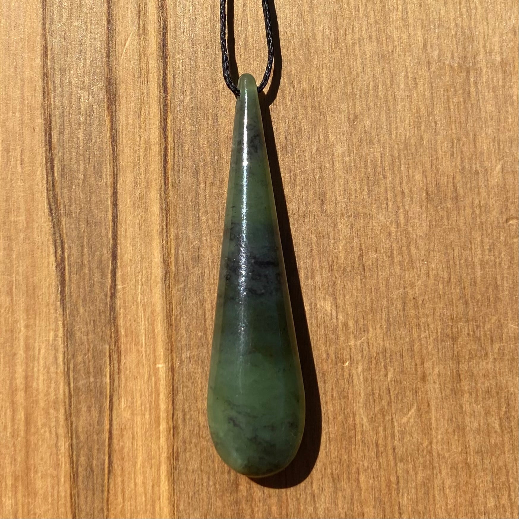 Toki pendant hand-carved from New Zealand kawawkawa pounamu (greenstone). 