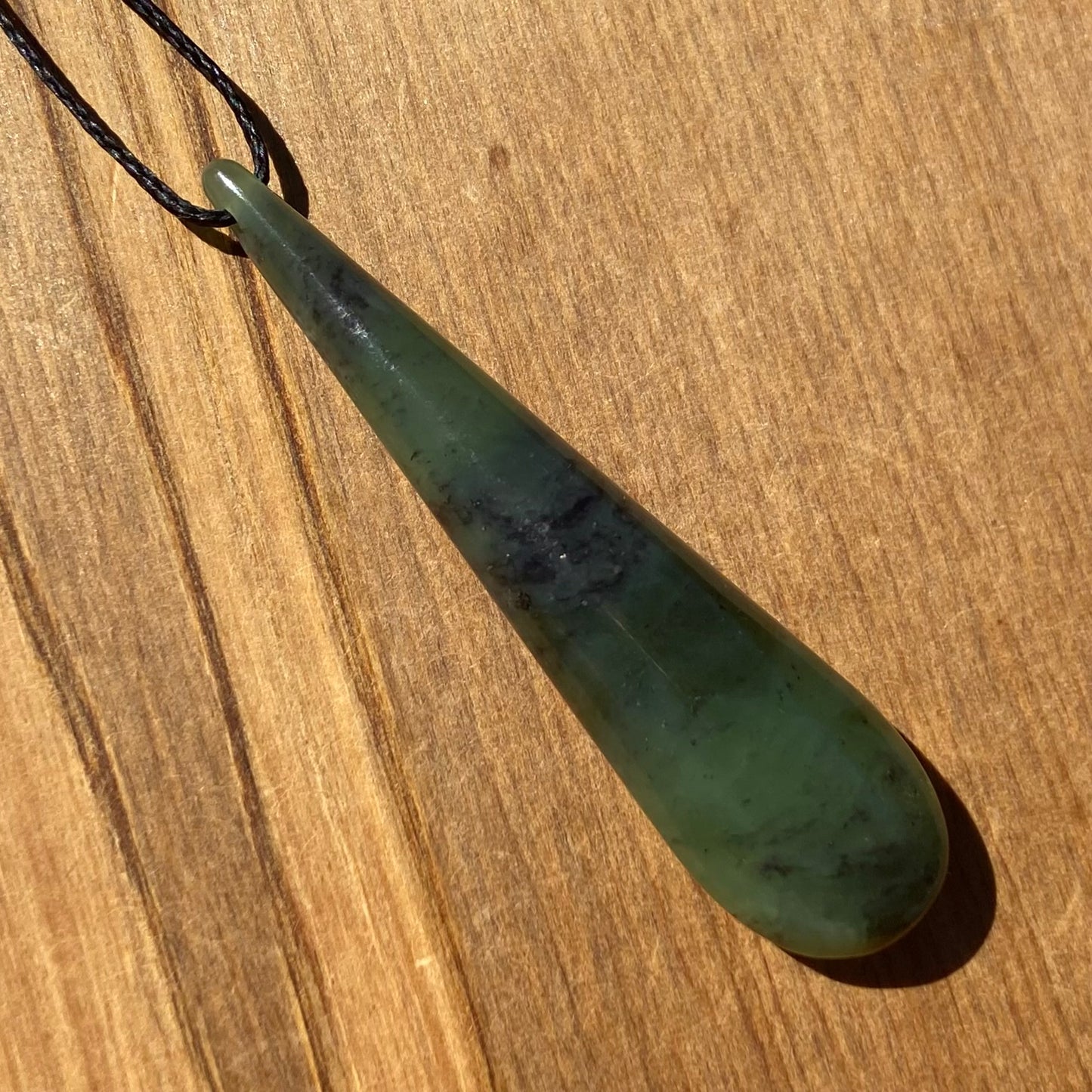 Toki pendant hand-carved from New Zealand kawawkawa pounamu (greenstone). Angle.