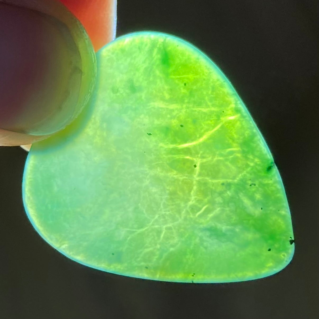 Guitar pick hand-carved from New Zealand Kahurangi Greenstone pounamu (greenstone). Translucency.